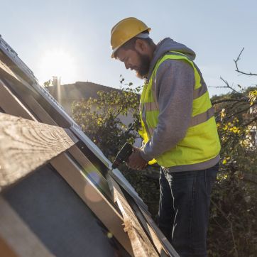 man working roof with drill scaled man working roof with drill scaled